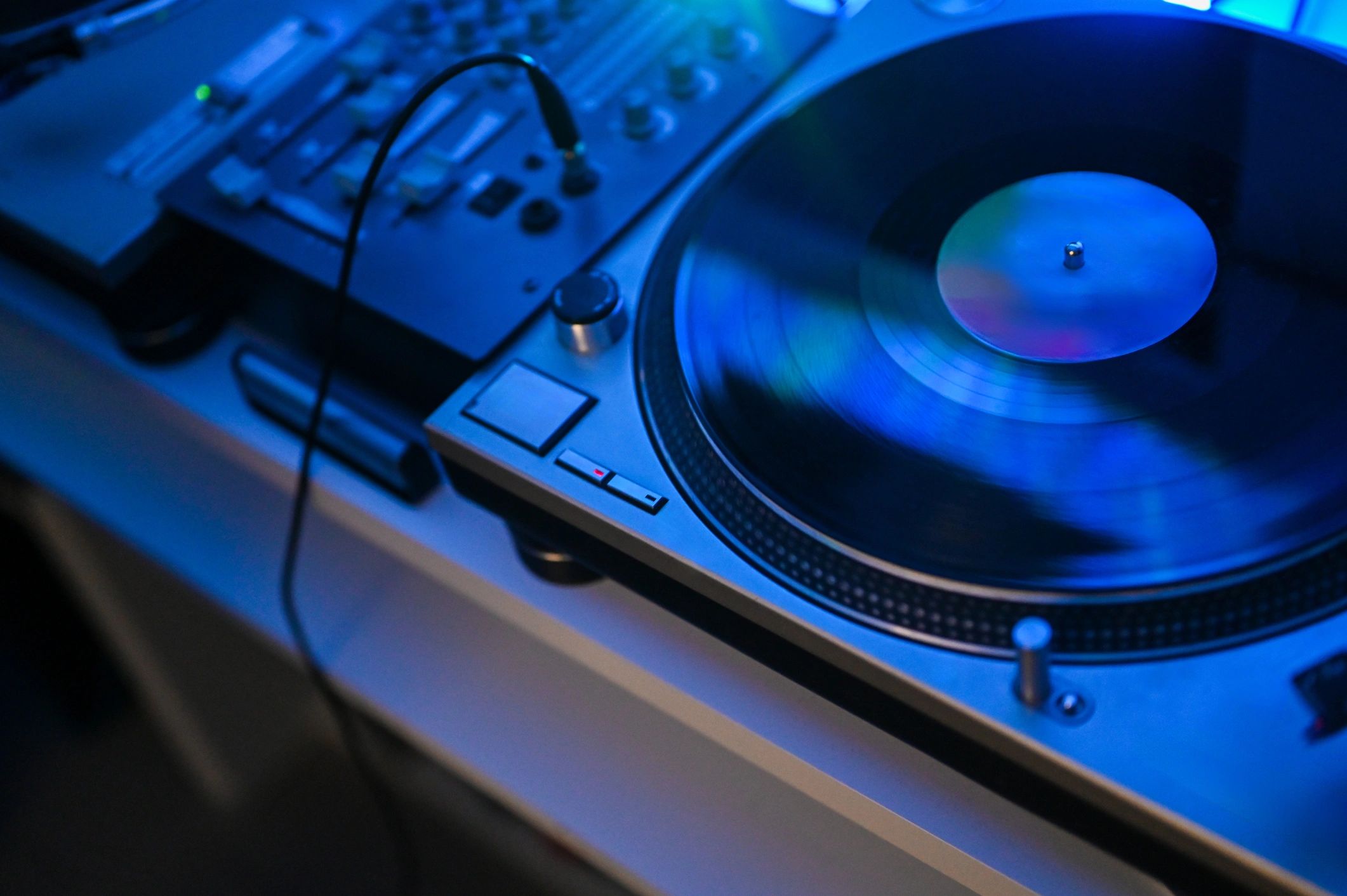 Turntable spinning a vinyl record with DJ mixer